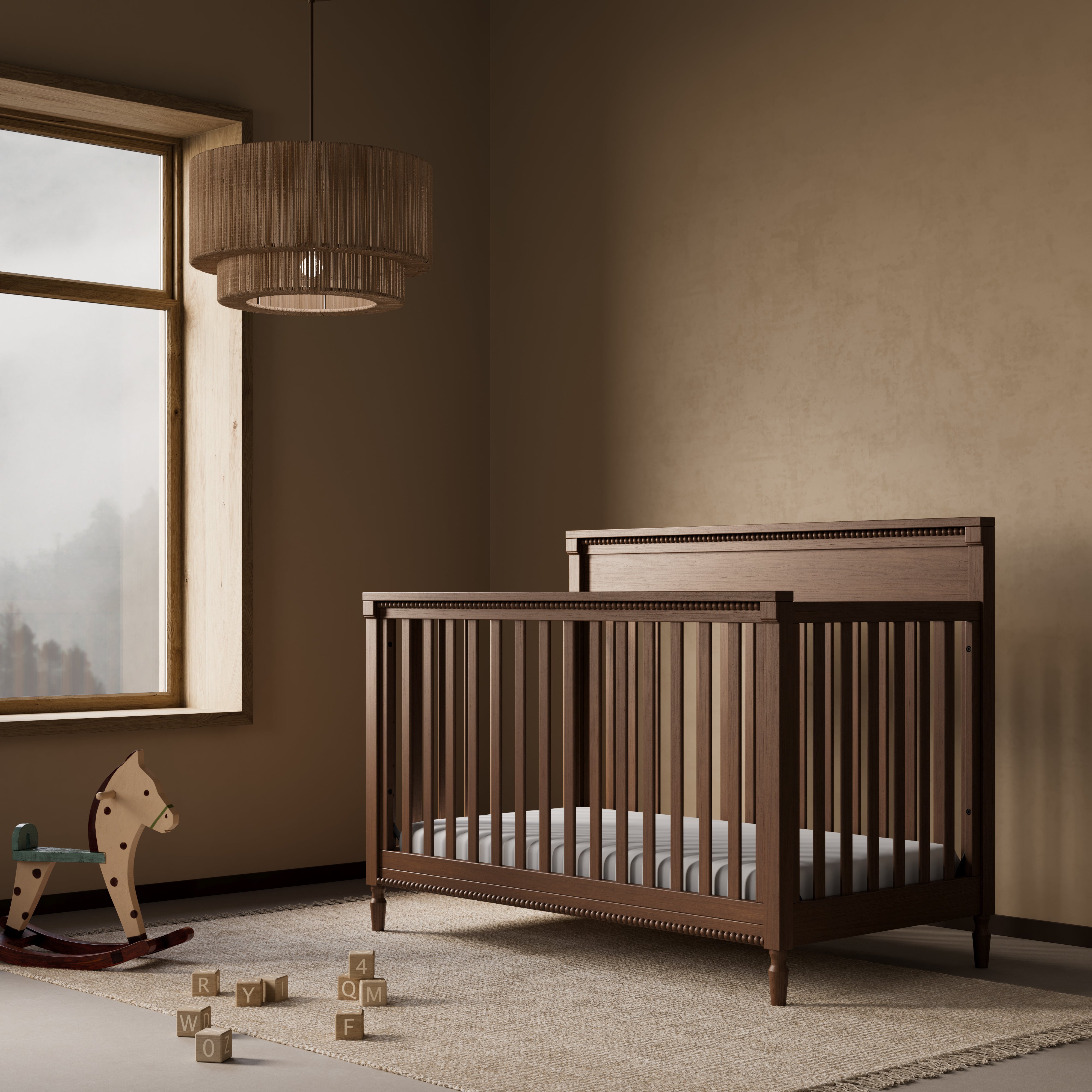 Storkcraft Valencia 5-in-1 Convertible Crib in Hazelnut Lifestyle Image in a nursery 