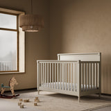 Storkcraft Valencia 5-in-1 Convertible Crib in Frosted Oat Lifestyle Image in a nursery 
