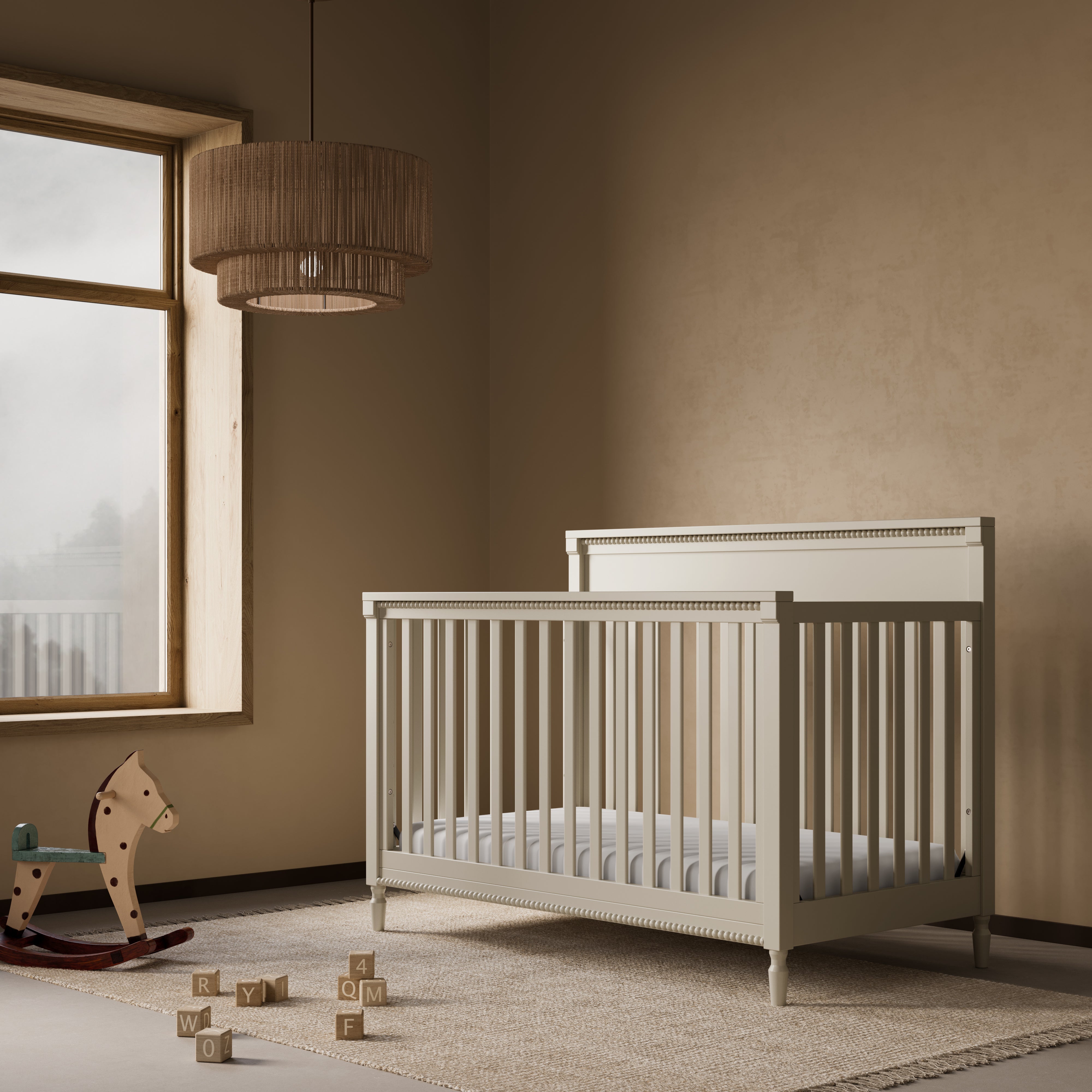Storkcraft Valencia 5-in-1 Convertible Crib in Frosted Oat Lifestyle Image in a nursery 
