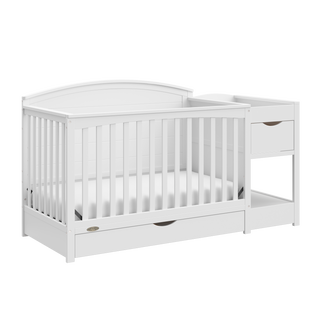 angled view of white convertible crib and changer