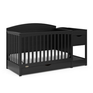 angled view of black convertible crib and changer