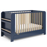 Graco Read-with-Me midnight blue with driftwood crib angle view