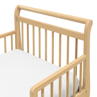 close up view of natural toddler bed with guardrails