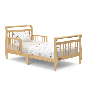 natural toddler bed with guardrails with bedding