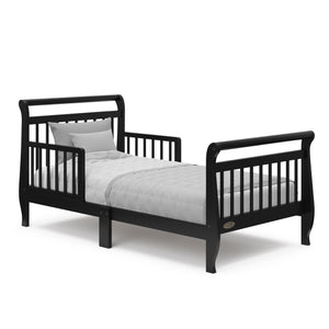 black toddler bed with guardrails and bedding