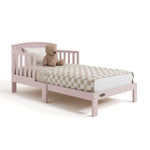 Benton blush toddler bed with bedding angle view
