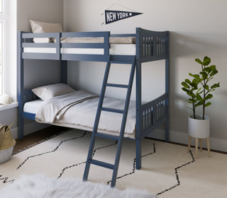  navy bunk bed with fixed ladder angled with bedding in a nursery
