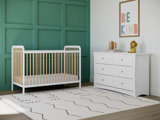 Nursery bedroom setting with crib, dresser, and various decorative nursery objects