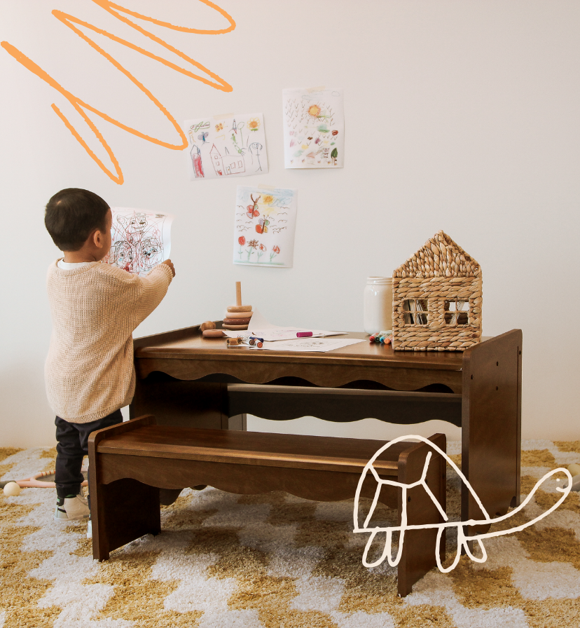 Storkcraft Safety. Image of toddler playing and drawing in playroom next to table set.