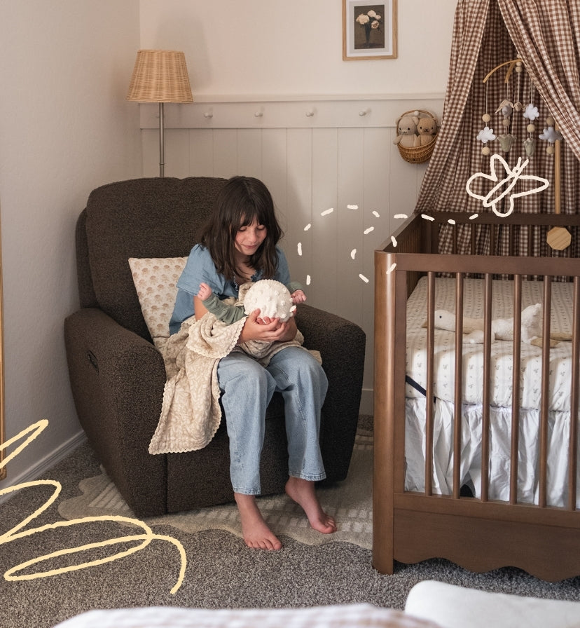 Image of baby and sister in the nursery bonding.