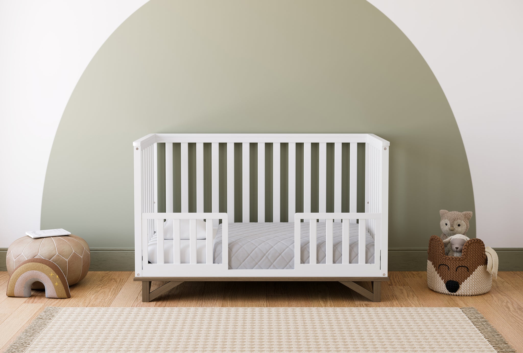 white crib in toddler bed conversion with two toddler safety guardrails, in nursery