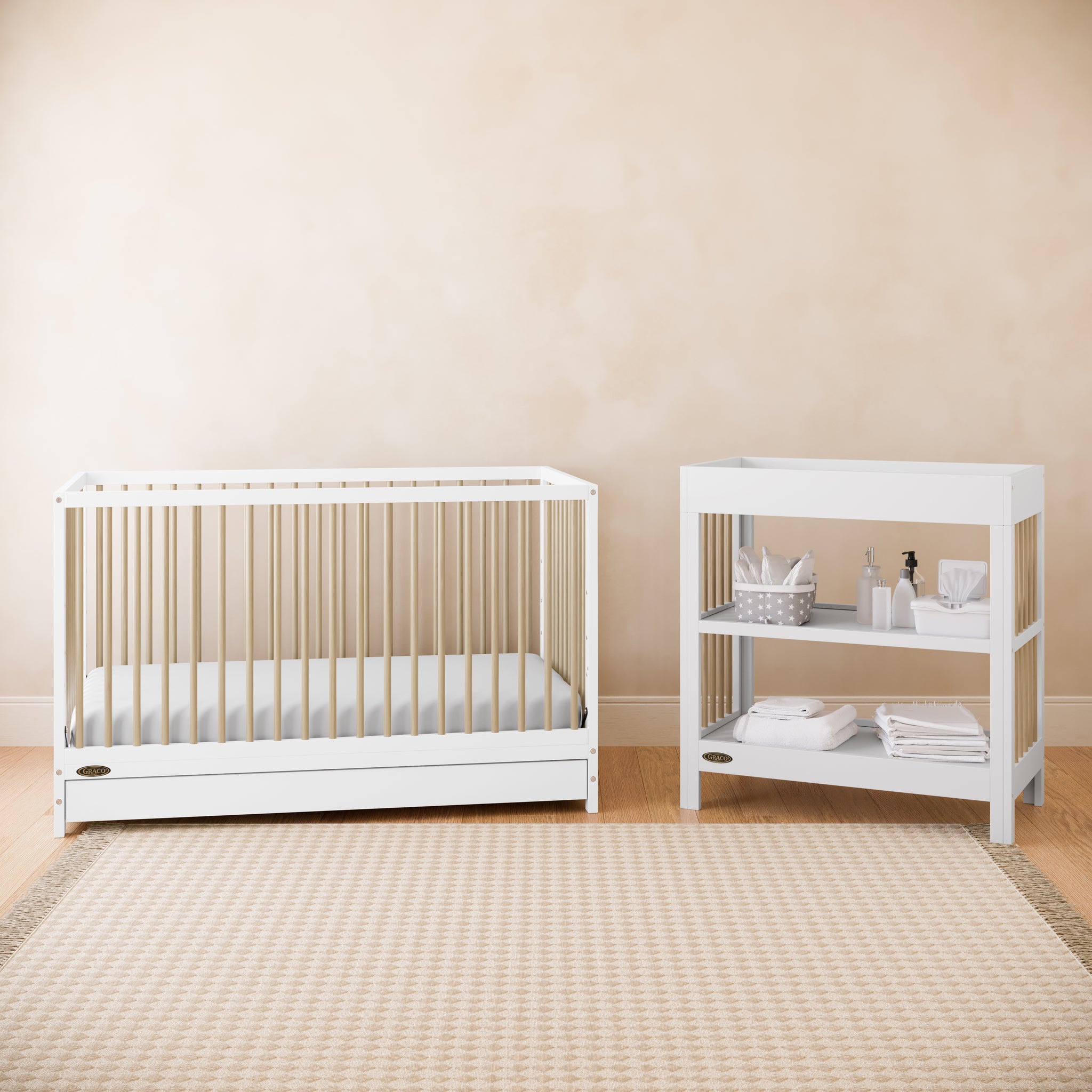 Two-tone white with light wood baby crib and changing table in nursery bedroom setting with rug in front of both items