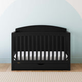 Convertible black crib in a nursery