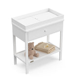 White Graco storage changing table top view with changing pad and baby items on shelf