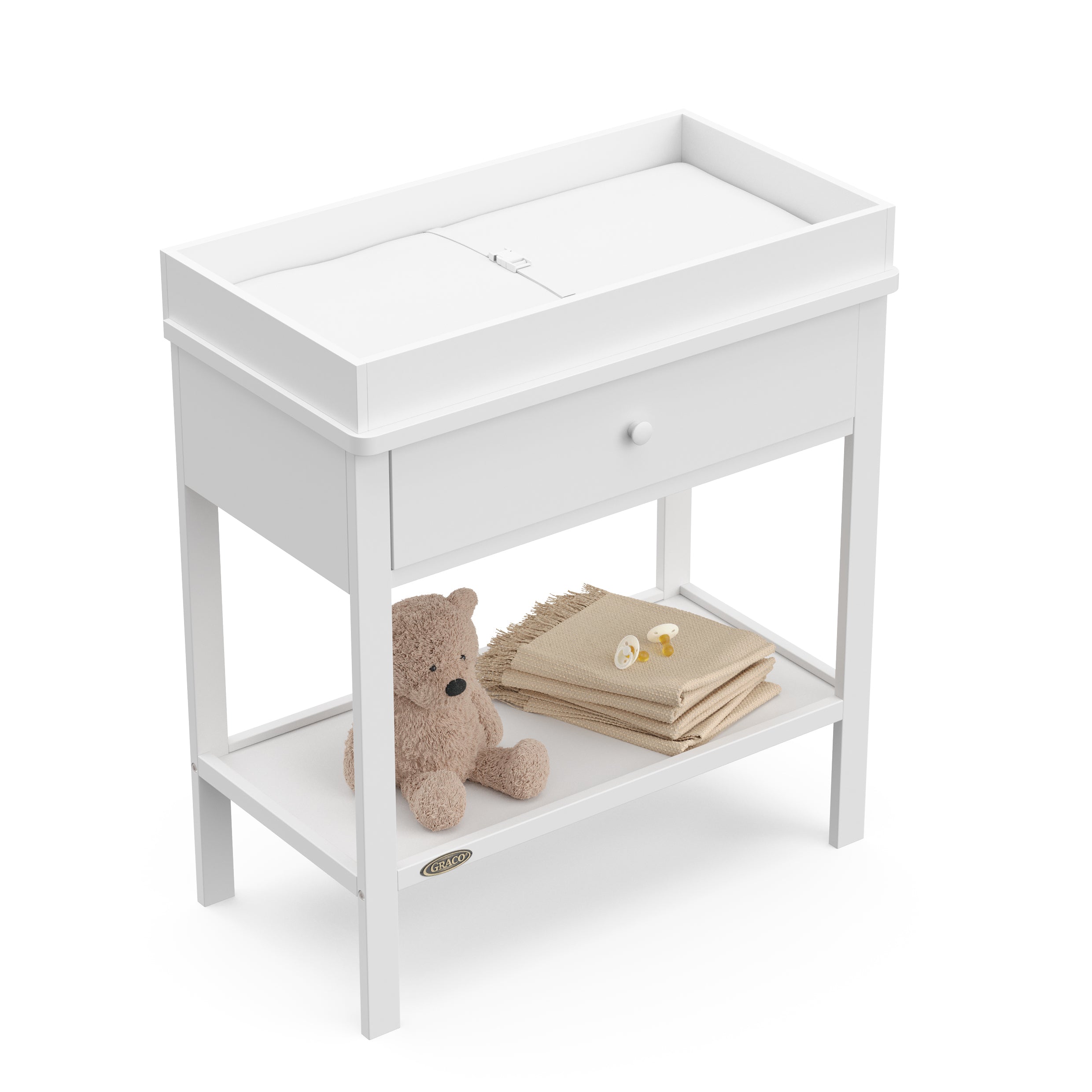 White Graco storage changing table top view with changing pad and baby items on shelf