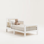 storkcraft pasadena white wtih driftwood toddler bed studio angle view with checkered bedding and teddy bear