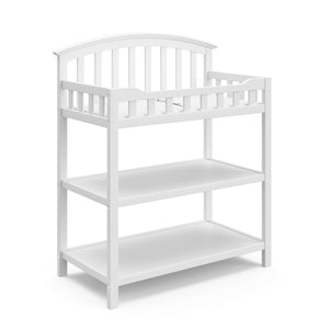 White angled changing table with two open shelves