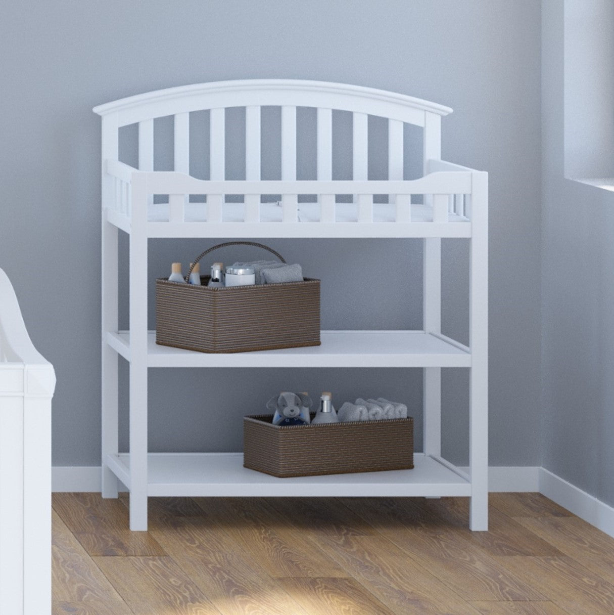 White changing table with two open shelves in nursery 