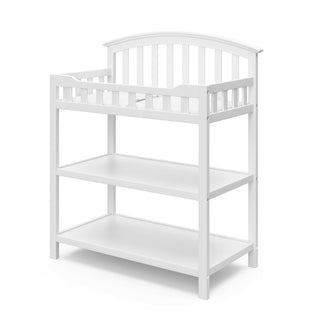 White angled changing table with two open shelves