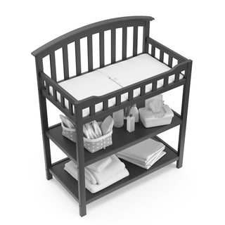 Bird’s-eye view of gray changing table with two open shelves