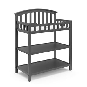 gray angled changing table with two open shelves