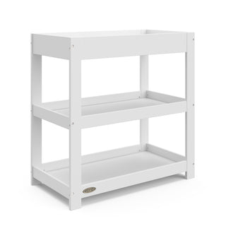 white angled changing table without headboard and two open shelves