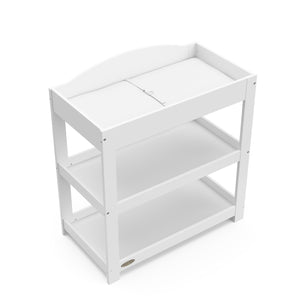 Bird’s-eye view of white changing table with removable headboard and two open shelves
