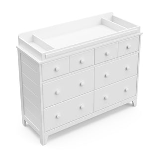 white changing topper on top of 6 drawer dresser 
