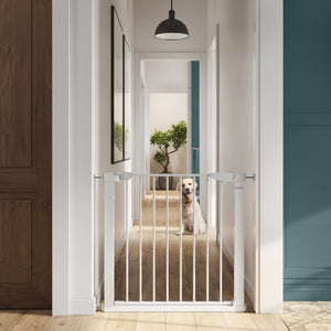 white safety gate installed on wall for dogs