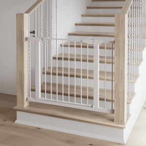 white safety gate installed in stairs
