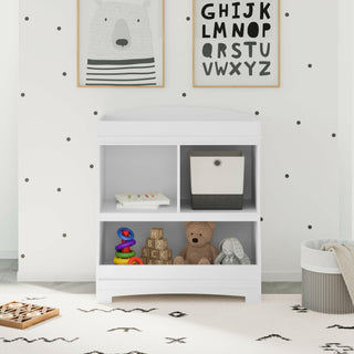 White changing table with storage in nursery 
