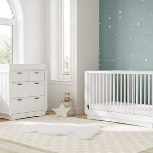 White 3 drawer chest with removable changing topper in nursery with crib