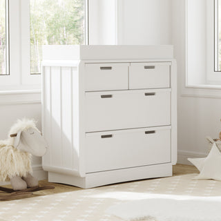 White 3 drawer chest with removable changing topper in nursery 