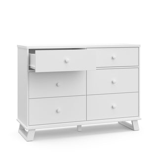 white 6 drawer dresser with one open drawer