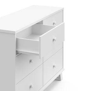 white 6 drawer dresser with one open drawer