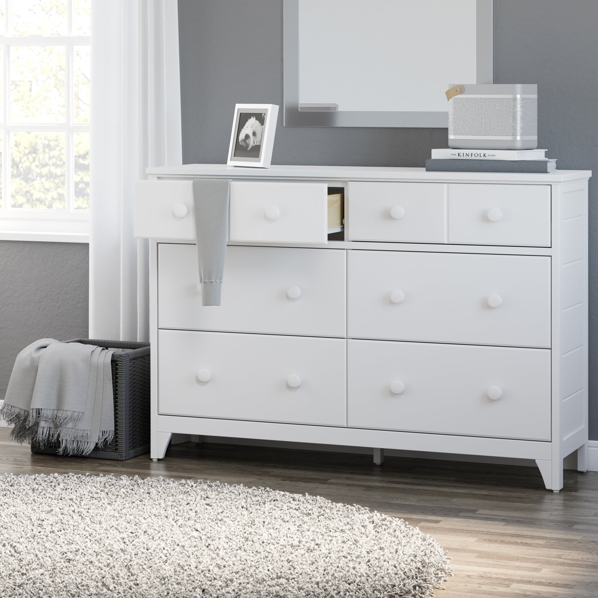 White 6 drawer dresser in nursery with one open drawer