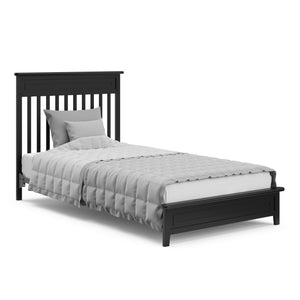 black crib in full-size bed conversion with headboard