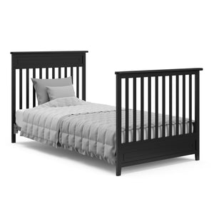black crib in full-size bed conversion with headboard and footboard