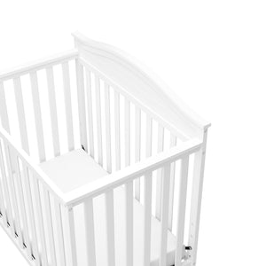 Close-up view of white crib's headboard