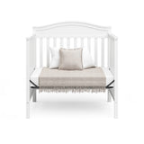 Graco® Stella 4-in-1 Convertible Mini Crib with Bonus Water-Resistant Mattress.