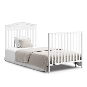 White crib in full-size bed with headboard and footboard conversion