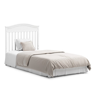 White crib in full-size bed with headboard conversion