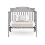 Graco® Stella 4-in-1 Convertible Mini Crib with Bonus Water-Resistant Mattress.