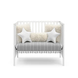 white mini crib in daybed conversion