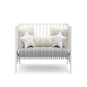 white mini crib in daybed conversion