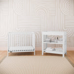 white mini crib in nursery
