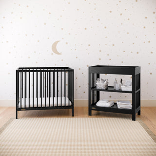 black mini crib in nursery