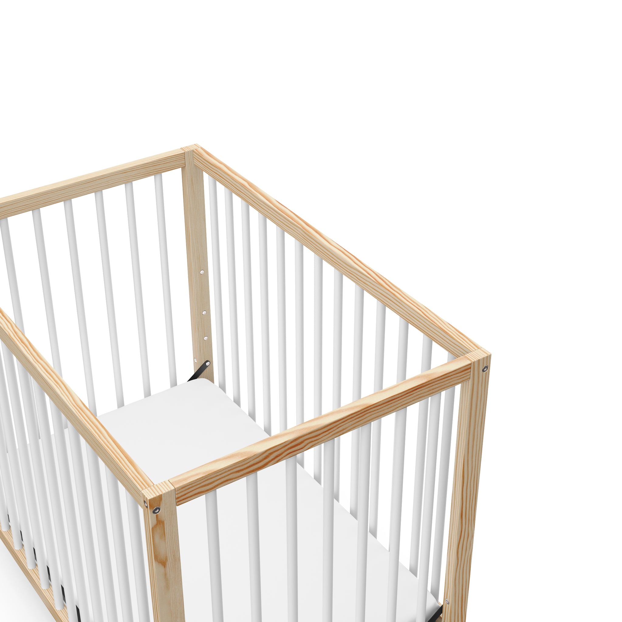 close-up view of Natural with white mini crib's headboard