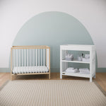 Graco® Teddi® 4-in-1 Convertible Mini Crib with Bonus Water-Resistant Mattress.