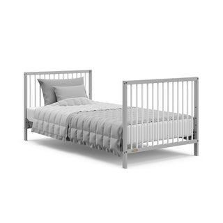 pebble gray with white mini crib in full-size bed with headboard and footboard